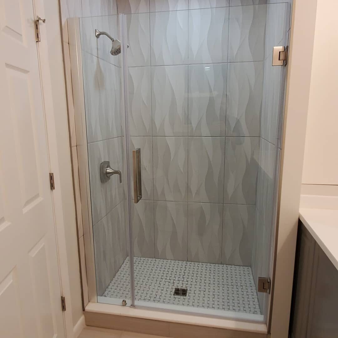 Frameless glass shower with patterned porcelain tile