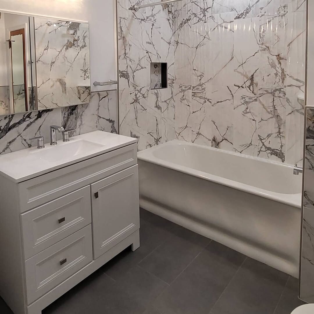 Hall bath with marble-look tub surround and new vanity