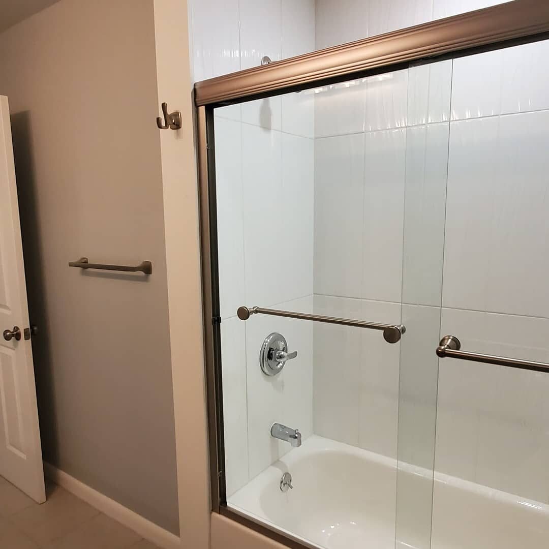 New tub with sliding glass doors and brushed-nickel fixtures