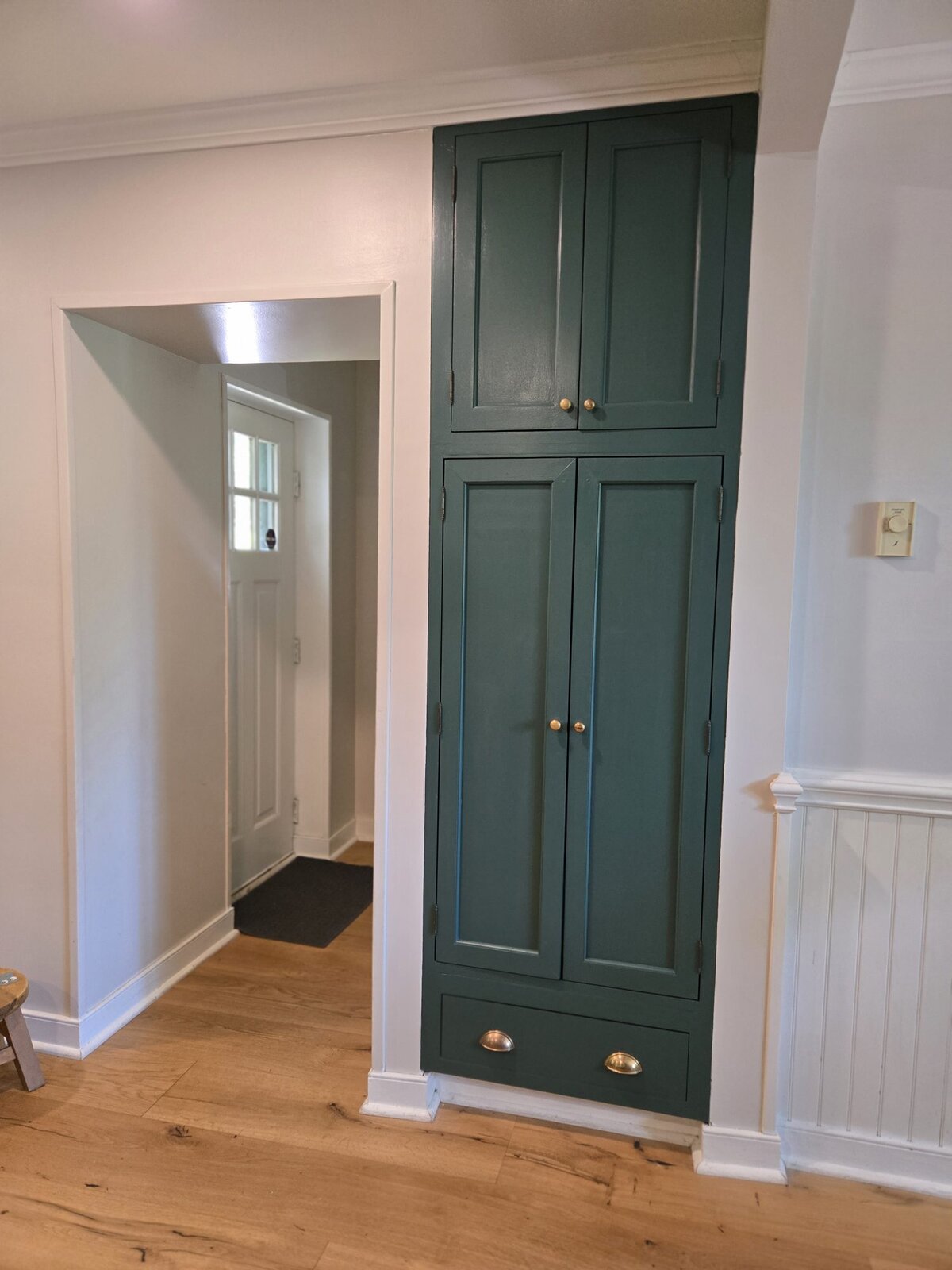 Full-height hunter-green pantry cabinetry