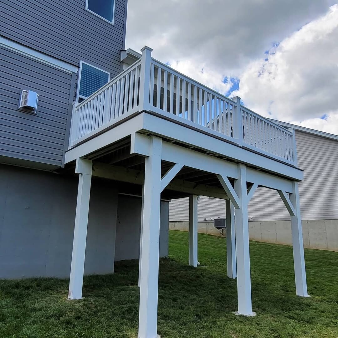 Elevated deck on structural posts with white railing