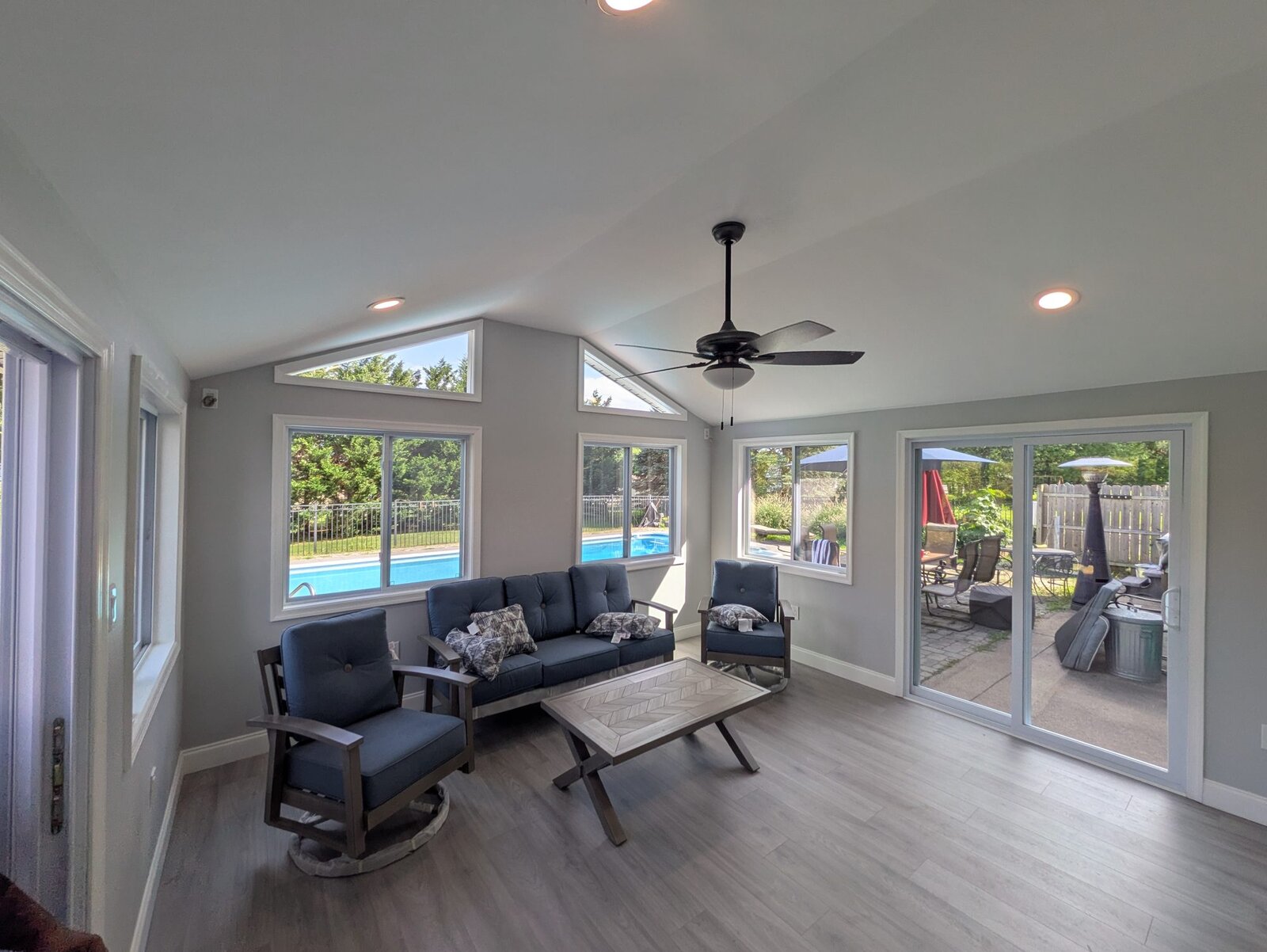 Sunroom addition with vaulted ceiling and walls of windows